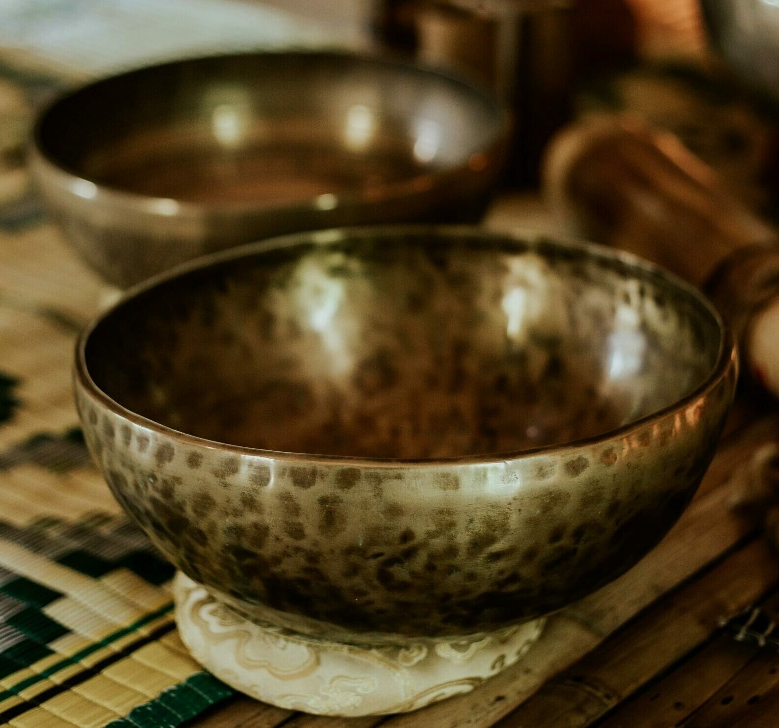 Close-up of Tibetan singing bowls, perfect for meditation and sound healing.